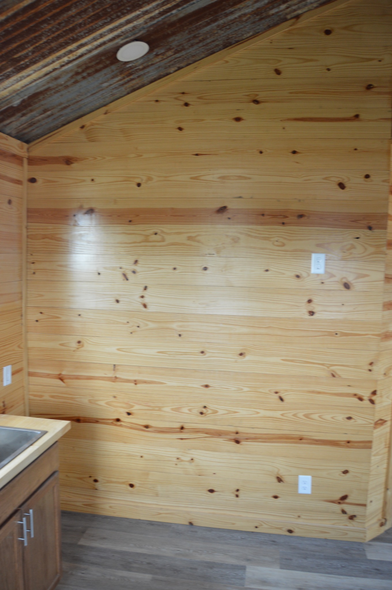 Horizontal knotty pine tongue-and-groove interior walls in the cabin